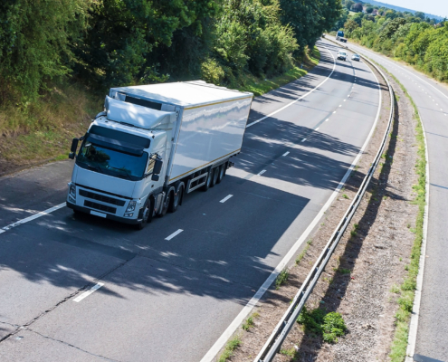 Side view of moving truck driving down the road